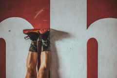 closeup photo of person wearing black and red low top sneakers